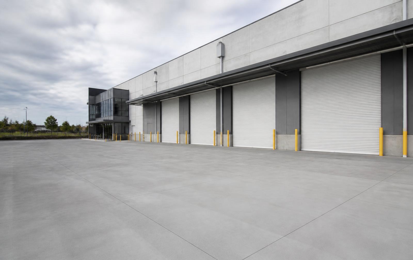 Concrete hardstand and loading dock aprons outside a warehouse